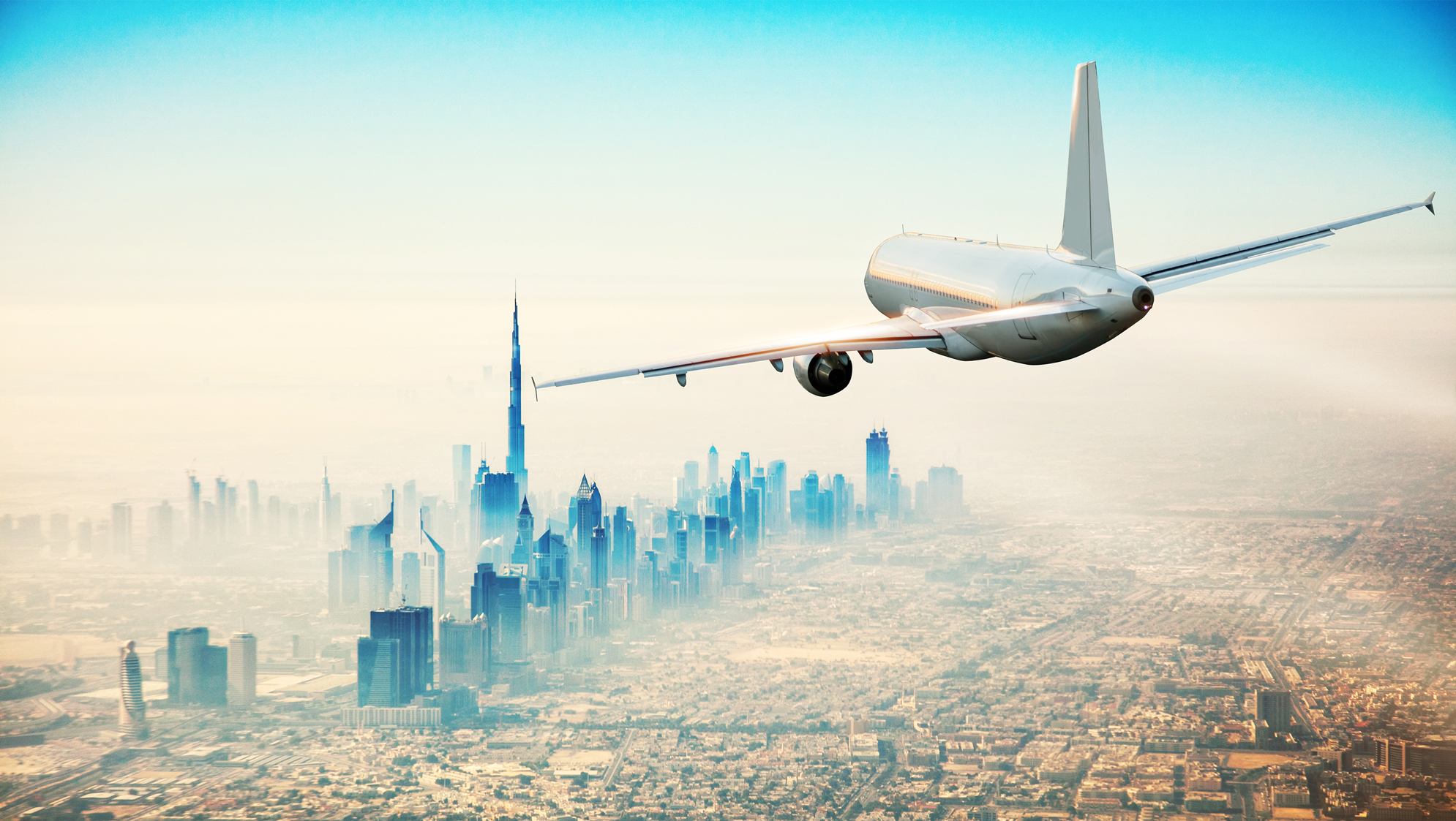 Graphic of an air freight plane flying towards a cityscape